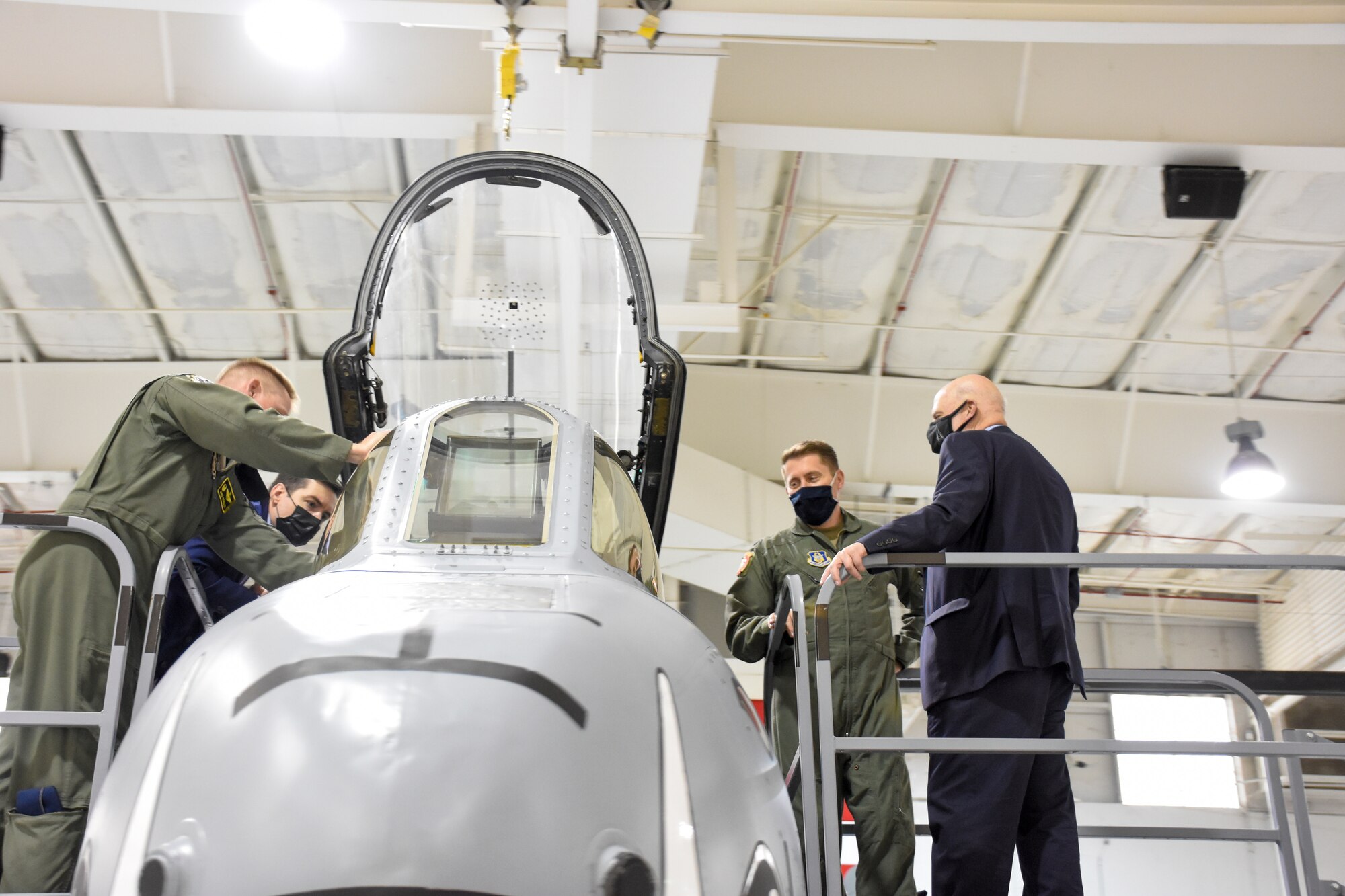 Air Force Lt. Col. Ryan Hodges (second from right), an A-10 pilot with the 303rd Fighter Squadron, gives a cockpit tour to Acting Secretary of the Air Force John Roth (far right).