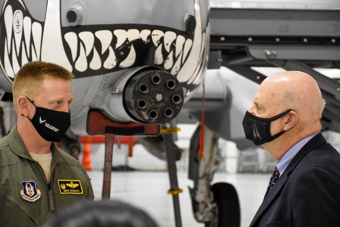 Acting Secretary of the Air Force John Roth speaks with Col. Michael Schultz, the 442d Fighter Wing commander, in front of an A-10 Thunderbolt II.