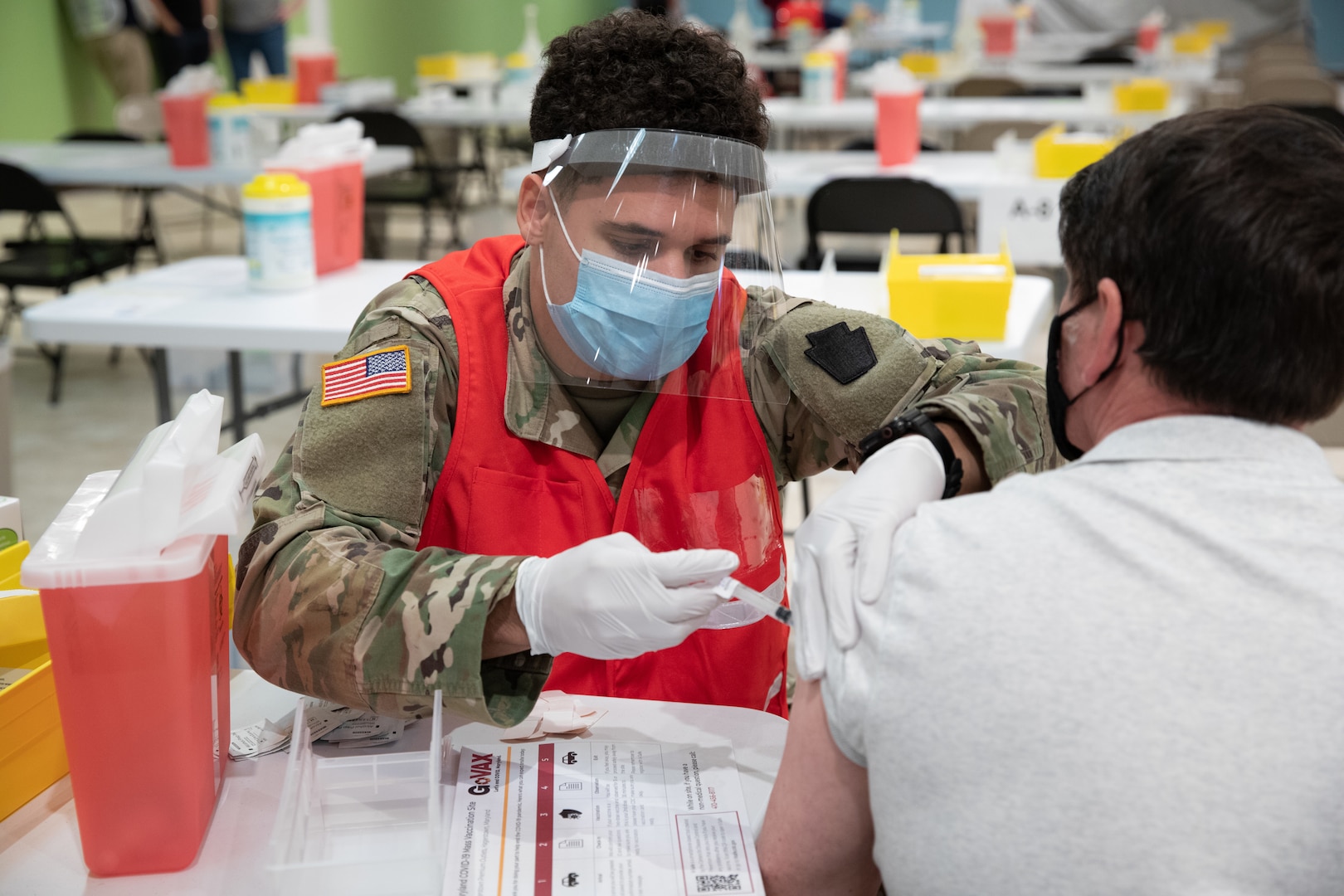 Spc. Isiah Bingham, a health care specialist with the Maryland Army National Guard’s Headquarters and Headquarters Company, 1st Battalion, 175th Infantry Regiment, administers a COVID-19 vaccine at a mass vaccination site in Hagerstown, Maryland, March 26, 2021. The site was the sixth COVID-19 mass vaccination site set up in Maryland.