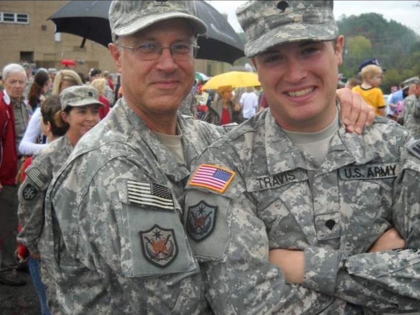 Two soldiers pose for a photo.