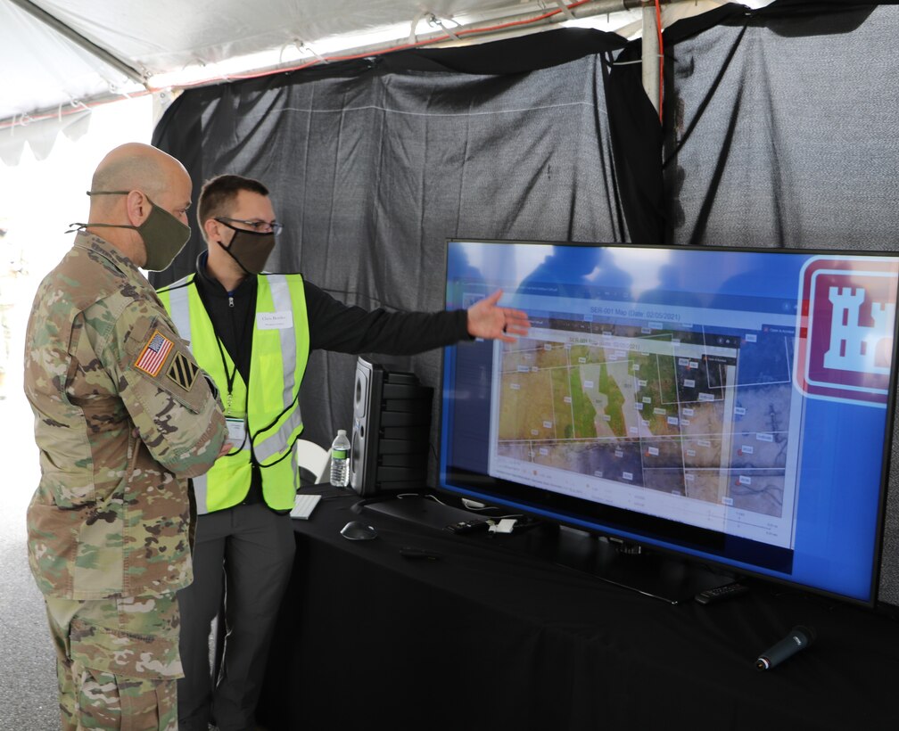 Chris Bowles, a Senior Project Manager from Ramboll, briefs Lt. Gen. Scott A. Spellmon on the digital database integration (DDI) platform that enables real-time digital data collection, modeling, and reporting to enhance environmental remediation efforts at the Chambers Works site in Deepwater, NJ.