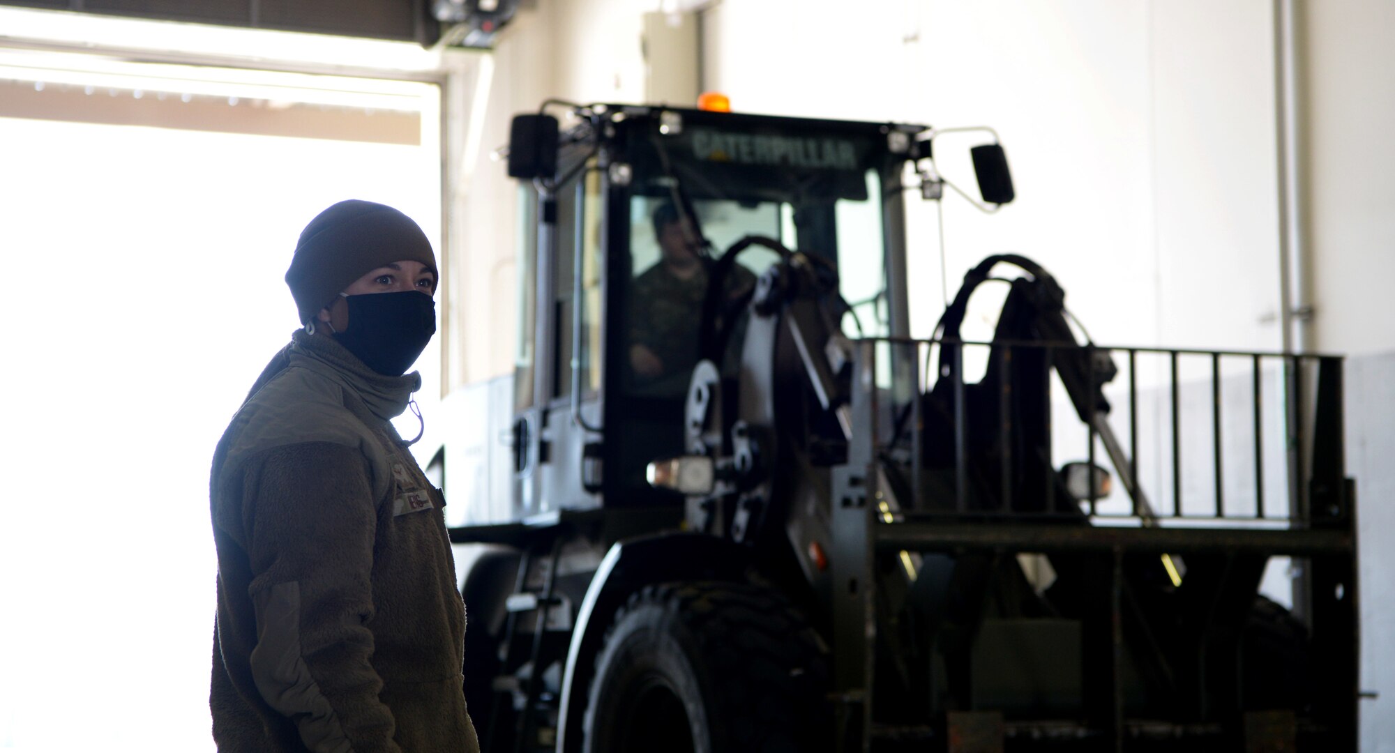 U.S Air Force Airman Destiny Nevis, a 354th Logistics Readiness Squadron Fuels Distrobution operator, directs a forklift during Arctic Gold (AG) 21-1 April 6, 2021, on Eielson Air Force Base, Alaska. During AG 21-2, the 354th LRS is responsible for receiving, weighing, securing and loading cargo for the deploying units. (U.S. Air Force photo by Senior Airman Beaux Hebert)
