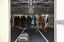 Airmen from the 354th Fighter Wing observe the Lightning Modular Extendable Rigid Wall Shelter (LMERWS) during Arctic Gold 21-2 April 6, 2021, at Eielson Air Force Base, Alaska. The LMERWS is a deployed debrief facility for F-35A Lightning II fighter squadrons .(U.S. Air Force photo by Senior Airman Keith Holcomb)
