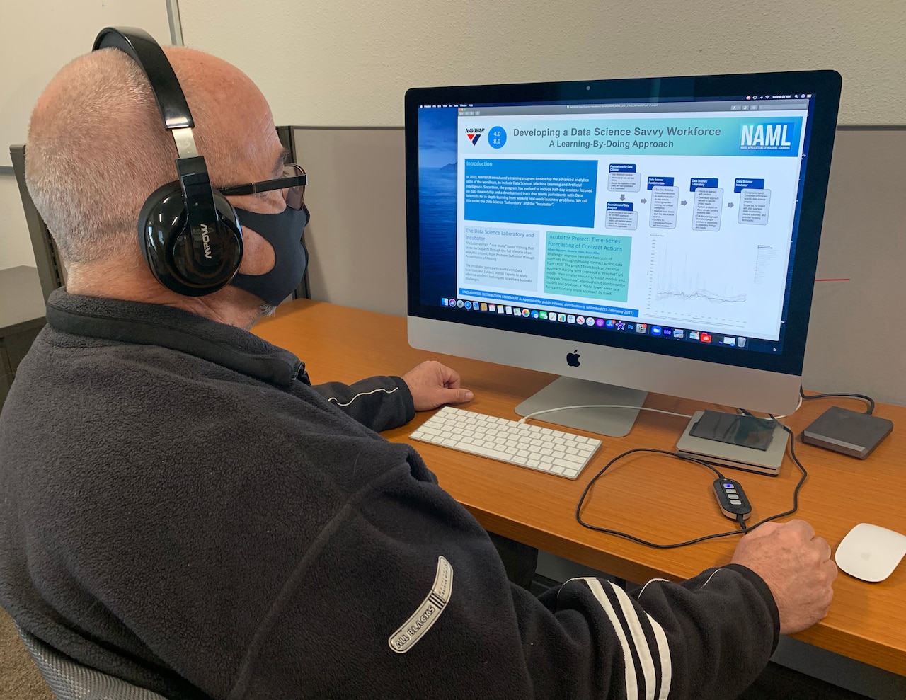 A man sits at a computer.