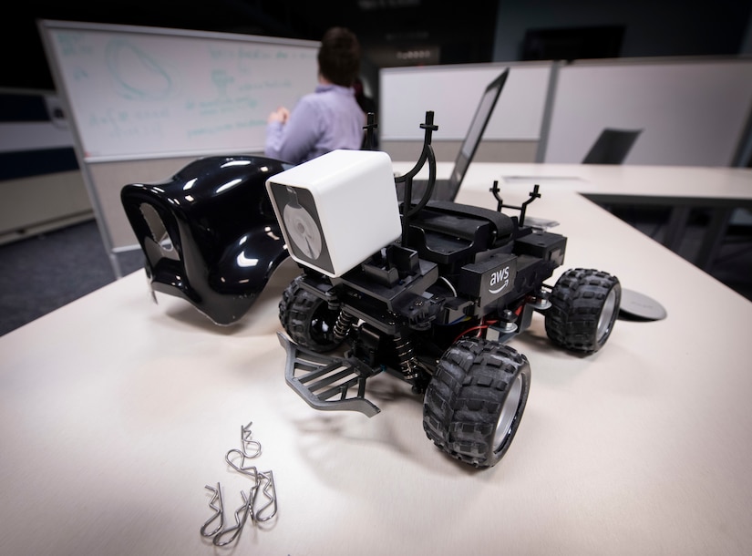 A small ground vehicle sits on desk.