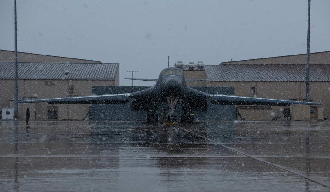 Light snow falls on a B-1B Lancer being prepared for a Bomber Task Force mission at Ellsworth Air Force Base, S.D., April 6, 2021.