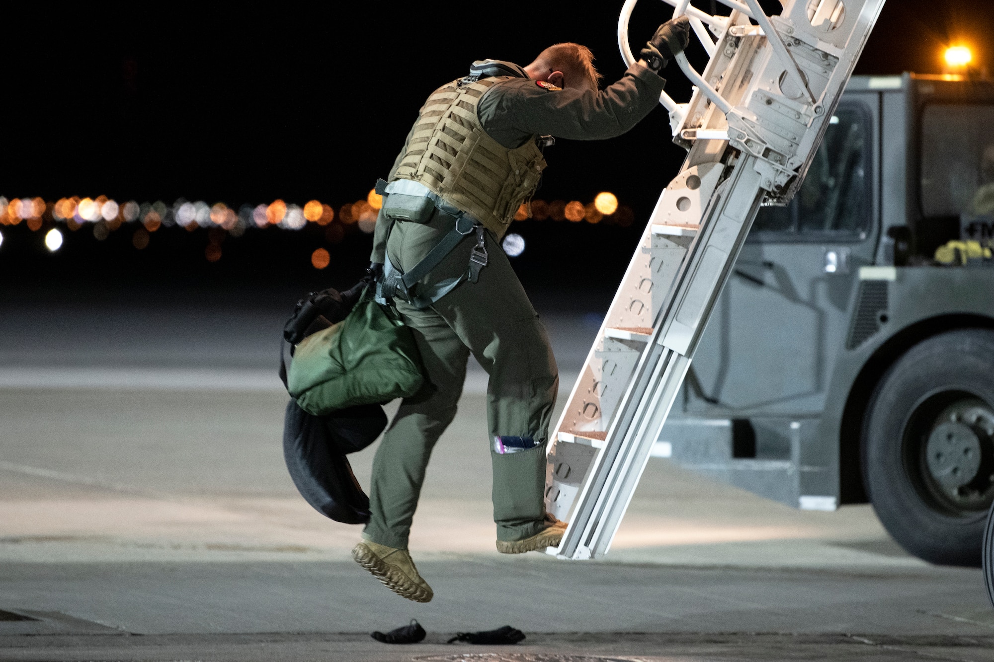 An aviator from the 37th Bomb Squadron steps down from a B-1B Lancer after returning from a Bomber Task Force mission at Ellsworth Air Force Base, S.D., April 7, 2021.