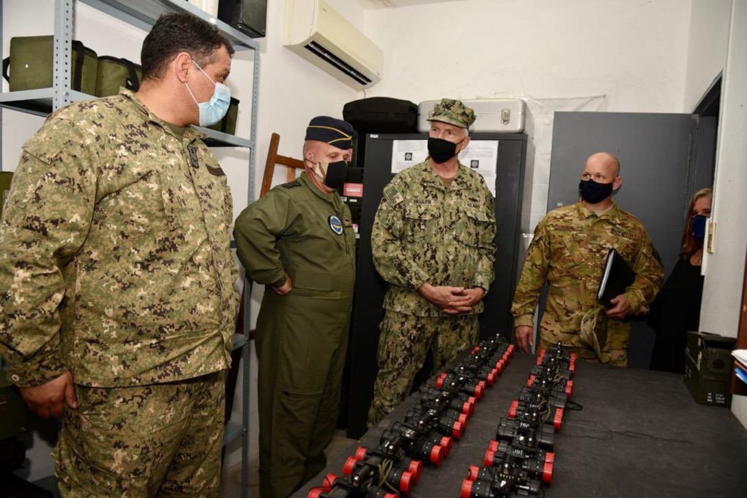 .S. Southern Command’s commander, Navy Adm. Craig Faller, is briefed on helicopter parts and equipment donated by the United States to the Uruguayan military.