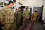 .S. Southern Command’s commander, Navy Adm. Craig Faller, is briefed on helicopter parts and equipment donated by the United States to the Uruguayan military.
