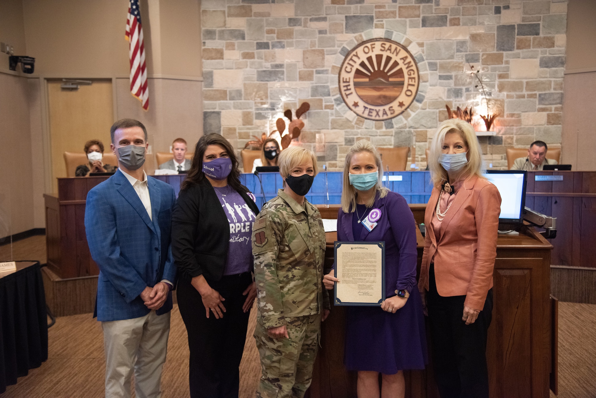 San Angelo Independent School District Superintendent, Dr. Carl Dethloff, Goodfellow Child and Youth Services School Liaison, Theresa Goodwin, Chief Master Sgt. Casy Boomershine, 17th Training Wing command chief, and SAISD Executive Director of Communications, Whitney Wood, pose holding a proclamation of recognition for the Month of the Military Child, with Mayor of San Angelo, Brenda Gunter, during a monthly City Council meeting, April 6, 2021, at the McNease Convention Center, San Angelo, Texas. Gunter declared a city-wide recognition of April as the Month of the Military Child in thanks to military children and their families. (U.S. Air Force photo by Staff Sgt. Tyrell Hall)
