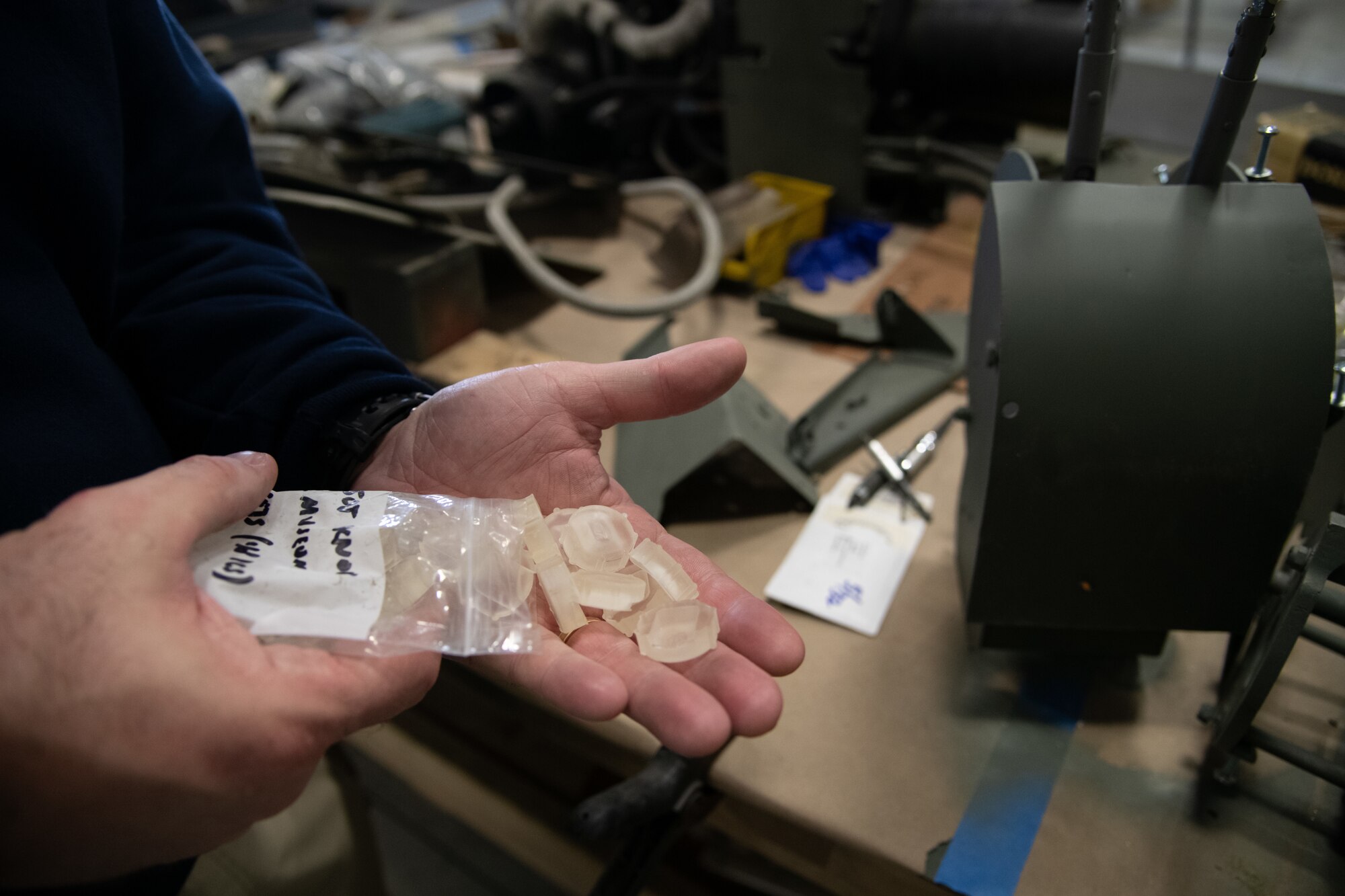 Eric Czerwinski, Air Mobility Command Museum deputy director, holds throttle handle knobs at Dover Air Force Base, Delaware, April 6, 2021. Airmen from Bedrock, the Dover AFB innovation lab, 3D printed the knobs to replace older ones. AMC Museum leaders plan on having the aircraft restored to display to future visitors. (U.S. Air Force photo by Senior Airman Marco A. Gomez)