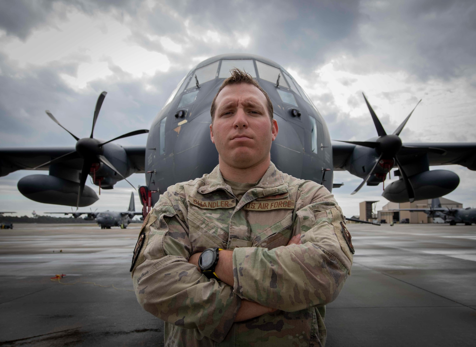 U.S. Air Force Tech. Sgt. Vincent Chandler, a special missions aviator with the 73rd Special Operations Squadron, stands in front of an AC-130J Ghostrider gunship at Hurlburt Field, Florida.