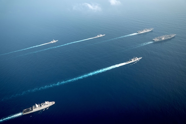 The Theodore Roosevelt Carrier Strike Group transits in formation with the Makin Island Amphibious Ready Group in the South China Sea, April 9, 2021.