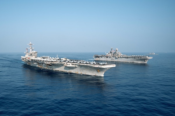 The Theodore Roosevelt Carrier Strike Group transits in formation with the Makin Island Amphibious Ready Group in the South China Sea, April 9, 2021.