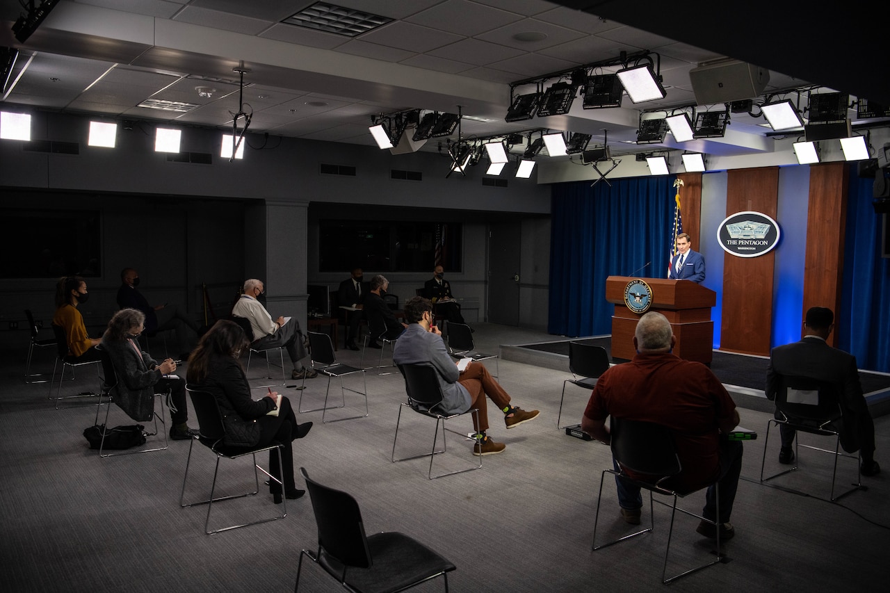 Man briefs reporters.