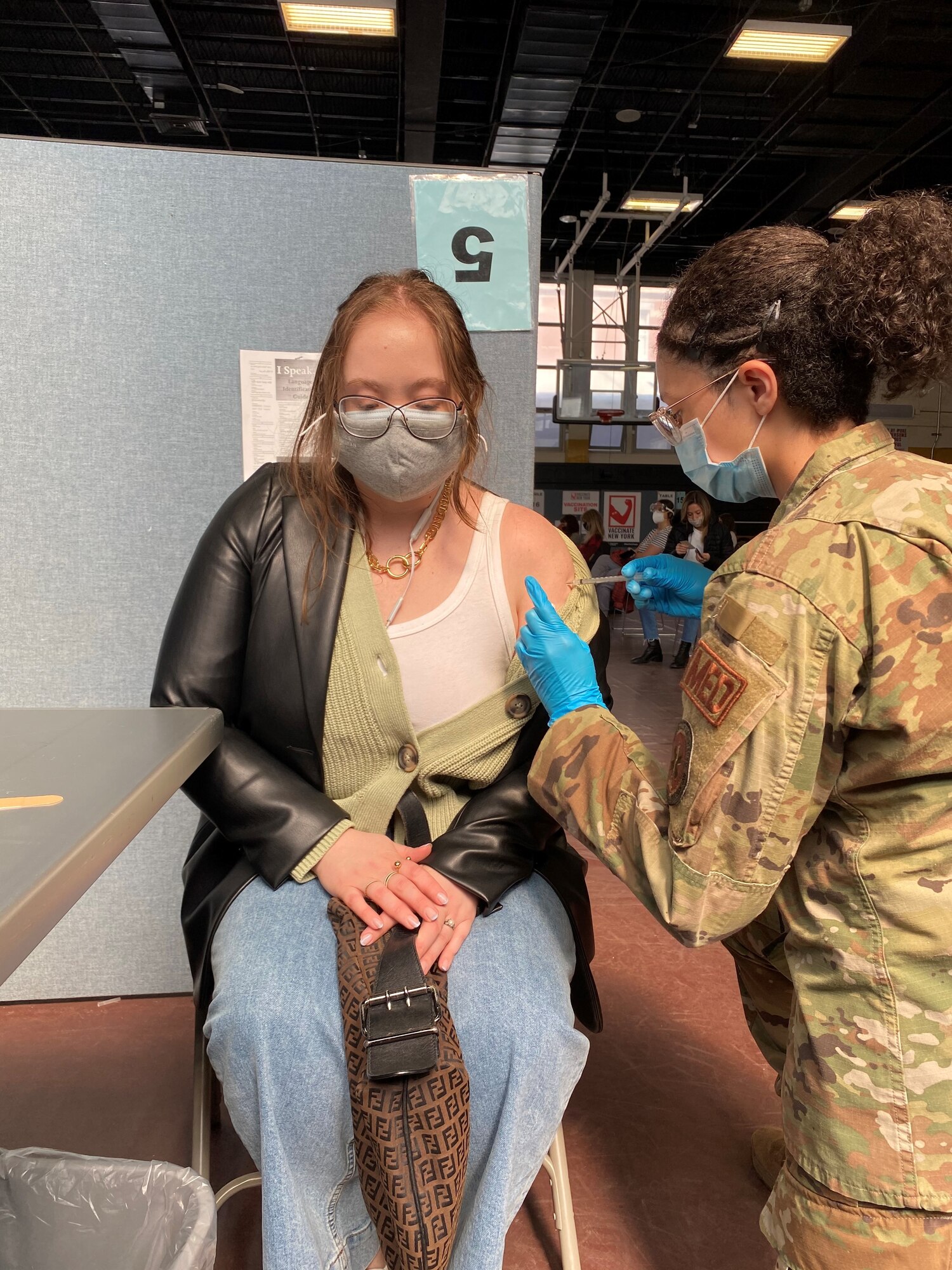 U.S. Air Force Senior Airman Arianna Gordon, 14th Health Care Operations Squadron Aerospace Medical technician, administers the Pfizer COVID-19 vaccine to patients while deployed under FEMA, at Medgar Evers College, Brooklyn, New York. Gordon is one of approximately 140 Airmen deployed from 28 installations to Brooklyn in support of the U.S. Army North’s COVID-19 response efforts. (Courtesy photo)