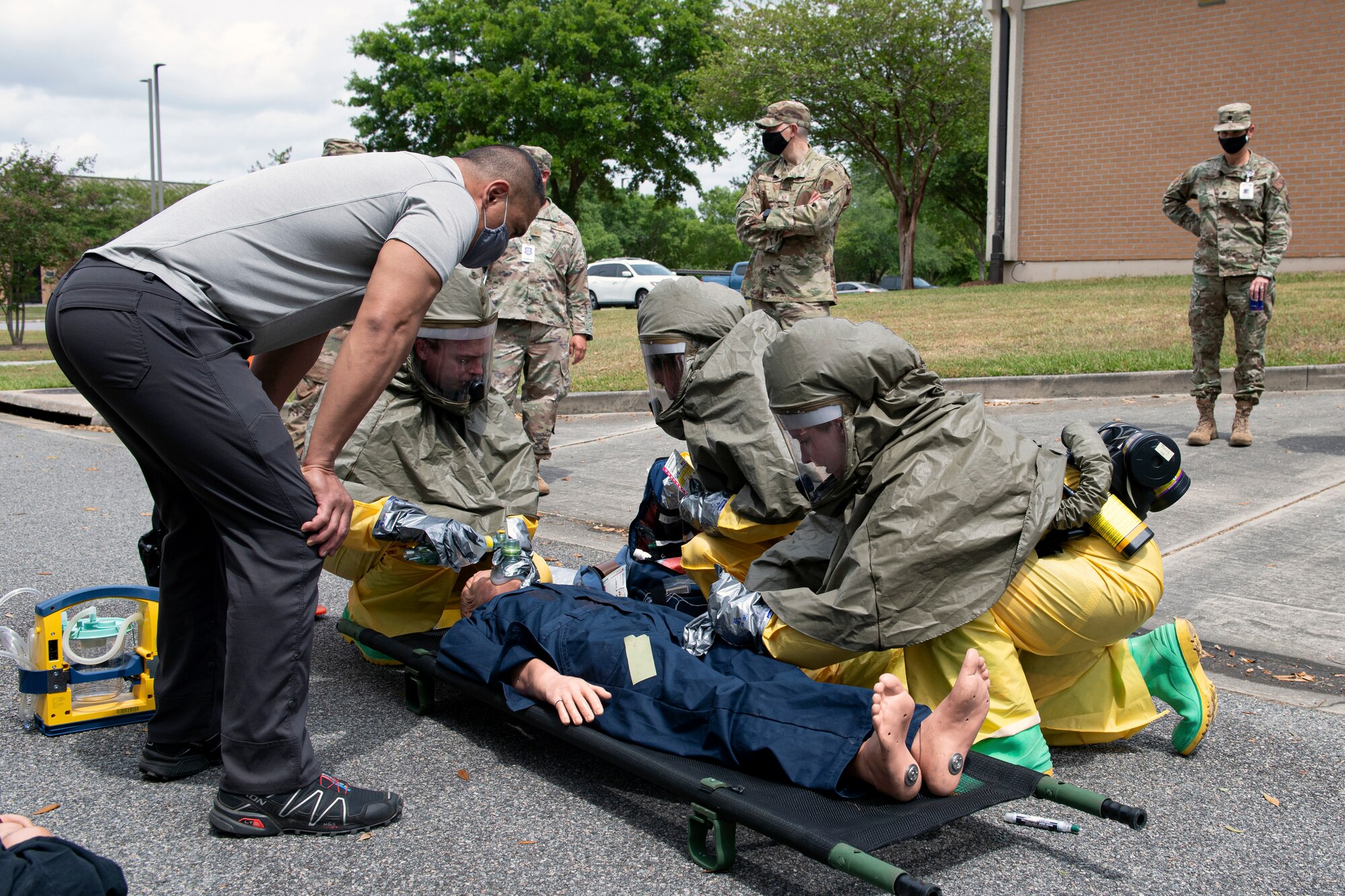 A photo of Airmen crowed around a mock body.