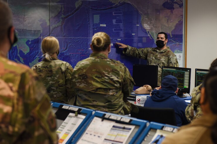 Photo of airman briefing a tour group