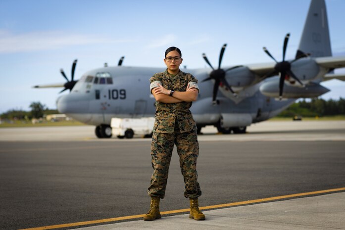 U.S. Marine Corps Cpl. Aileen Chavez Pacheco, an aviation operations specialist from Marine Corps Air Station Kaneohe Bay, Marine Corps Base Hawaii, poses for a picture in front of a C-130 cargo plane, MCBH, March 29, 2021. Cpl. Chavezpacheco was recently selected as the 2021 Marine Corps Installation Command Marine of the Year.