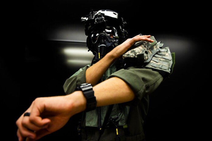 U.S. Marine Corps Capt. Matthew Desrochers, a Bell UH-1Y Venom Super Huey helicopter pilot with Marine Light Attack Helicopter Squadron 367, practices donning the MPU-5(V)/P joint service aircrew mask during a chemical, biological, radiological and nuclear flight simulation training event, Marine Corps Base Hawaii, March 31, 2021. The purpose of the training was to familiarize aircrew with donning, doffing, and performing basic flight operations while wearing the new CBRN gear. (U.S. Marine Corps photo by Lance Cpl. Brandon Aultman)