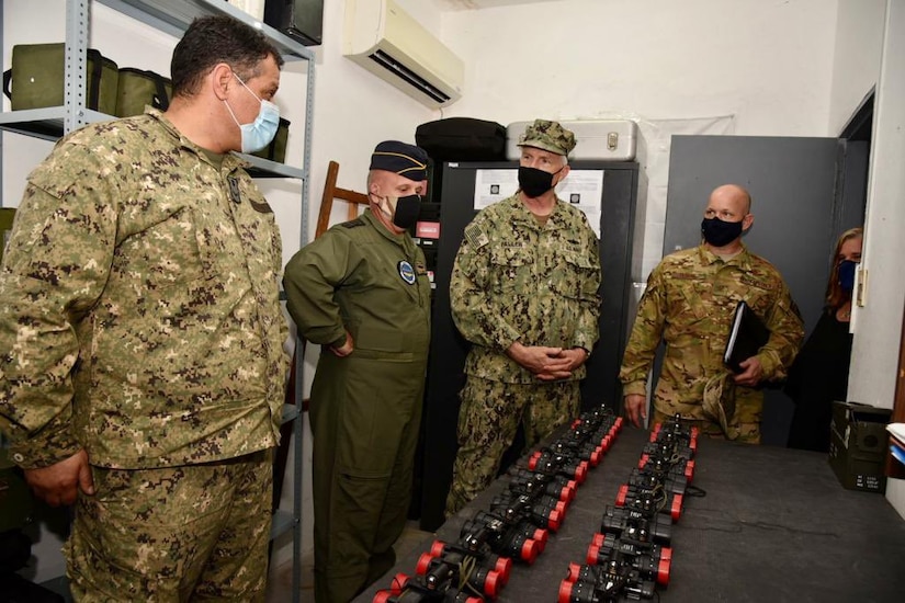 .S. Southern Command’s commander, Navy Adm. Craig Faller, is briefed on helicopter parts and equipment donated by the United States to the Uruguayan military.