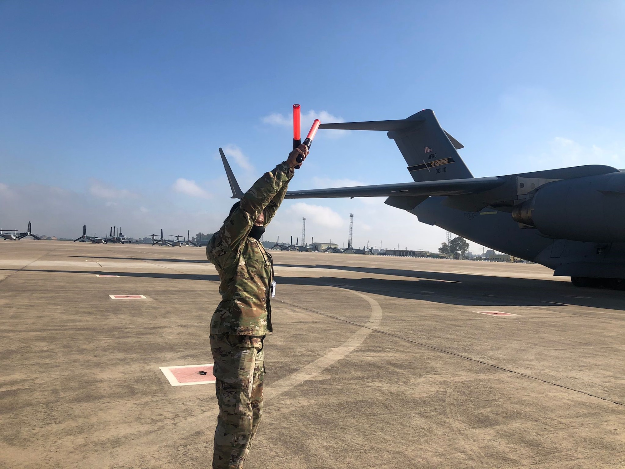 726th Air Mobility Squadron, Staff Sgt. Damien Cook halts a C-17 into parking position on his own, for the first time, after being trained by 725th Air Mobility Squadron maintainers at Morón Air Base, April 6, 2021. Since the beginning of March, Airmen of the 521st Air Mobility Operations Wing have been demonstrating the Wing’s Nodal Agile Combat Employment at the air base with a team of 21 Airmen. (U.S. Air Force photo by Staff Sgt. Michael Dodd)