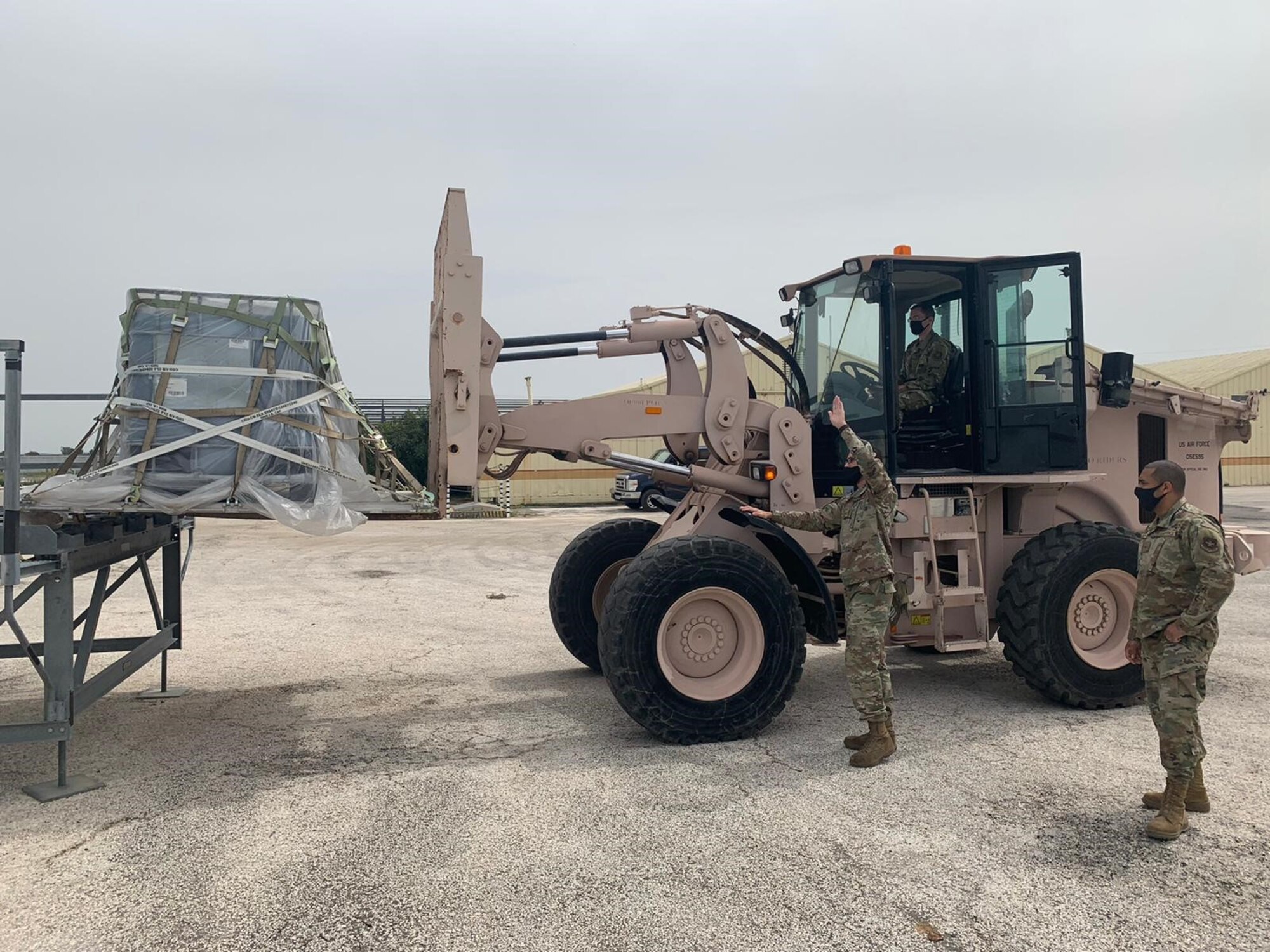 Tech. Sgt. Joseph Vanga, an Air Transportation specialist from the 721st Aerial Port Squadron, oversees maintainers from the 725th Air Mobility Squadron, Staff Sgt. Michael Dodd (spotter) and Staff Sgt. Chris Pine (driver), as they place aircraft equipment onto the high line docks at Morón Air Base, April 6, 2021. Since the beginning of March, Airmen of the 521st Air Mobility Operations Wing have been demonstrating the Wing’s Nodal Agile Combat Employment at the air base with a team of 21 Airmen. (U.S. Air Force photo by Staff Sgt. Michael Dodd)