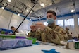 Senior Airman Benedict Barnett, a medic with the 193d Special Operations Wing, prepares band-aids at the Esperanza Community Vaccination Center in Philadelphia on April 8, 2021.