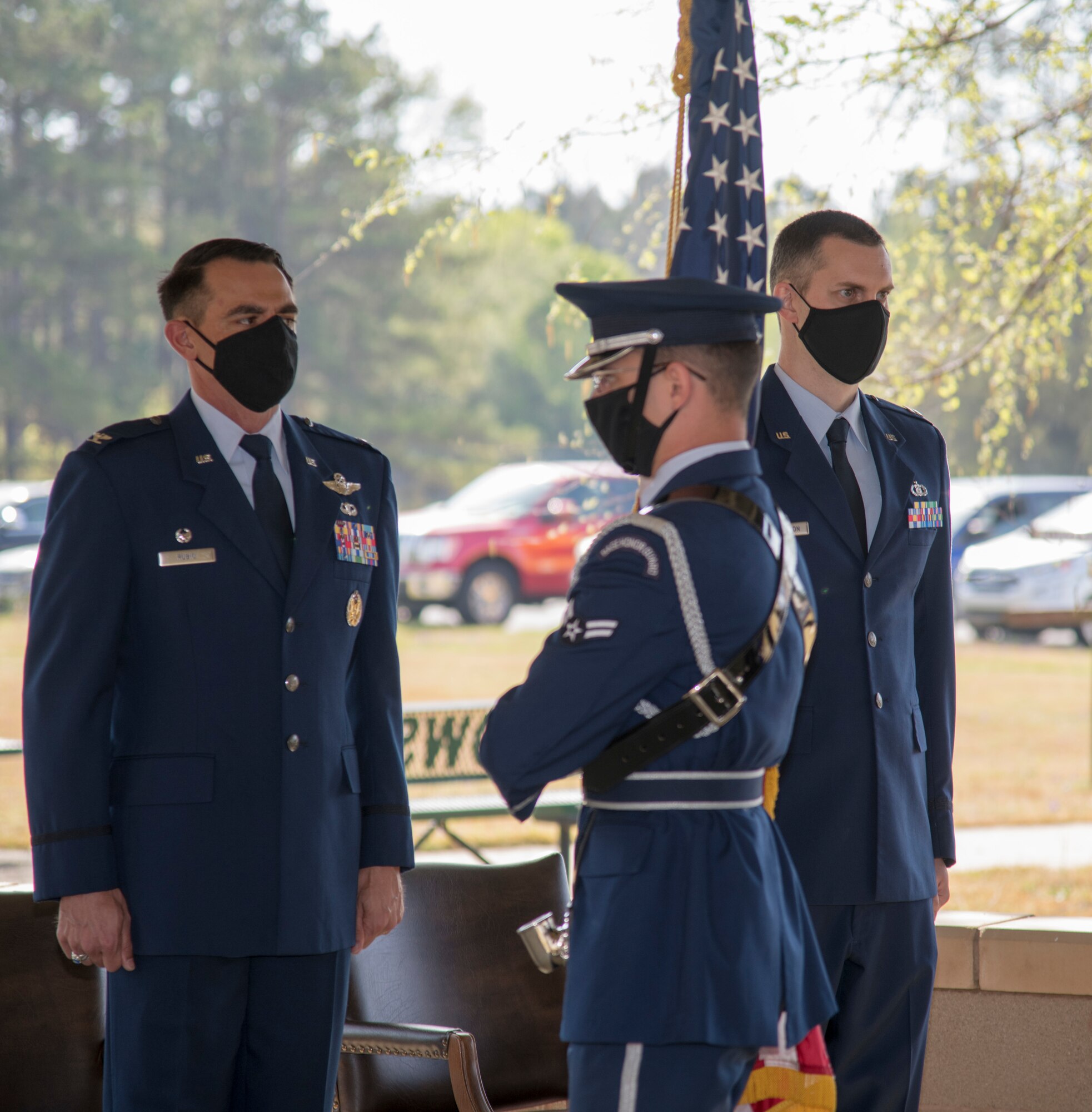 Col. Stuart M. Rubio, 403rd Operations Group commander at Keesler Air Force Base, Miss., and Capt. Grant J. Talkington, 5th Operational Weather Flight commander at Shaw Air Force Base, S.C., stand at attention as Airman 1st Class Baylor Smith passes by with the United States flag during an assumption of command ceremony at the 28th Operational Weather Squadron pavilion at Shaw April 9, 2021. The mission of the 5th OWF is to provide the world's most disciplined, trained, and effective reserve weather force ins support of U.S. Central, European, African, and STRATEGIC Commands anywhere, anytime. (U.S. Air Force photo by Staff Sgt. Kristen Pittman)