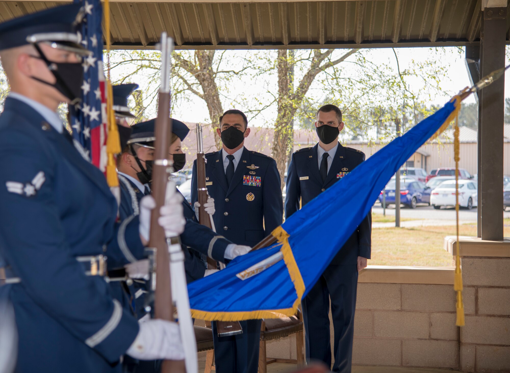 Col. Stuart M. Rubio, 403rd operations group commander at Keesler Air Force Base, Miss., and Capt. Grant J. Talkington, 5th Operational Weather Flight commander at Shaw Air Force Base, S.C., look on as members of the Shaw AFB honor guard present the colors during an assumption of command ceremony at the 28th Operational Weather Squadron pavilion at Shaw April 9, 2021. As commander, Talkington is responsible for the readiness, agile deployment, and effectiveness of unit members fulfilling exercise and contingency operations for base weather stations, operational weather squadrons and Air Operations Centers worldwide. (U.S. Air Force photo by Staff Sgt. Kristen Pittman)