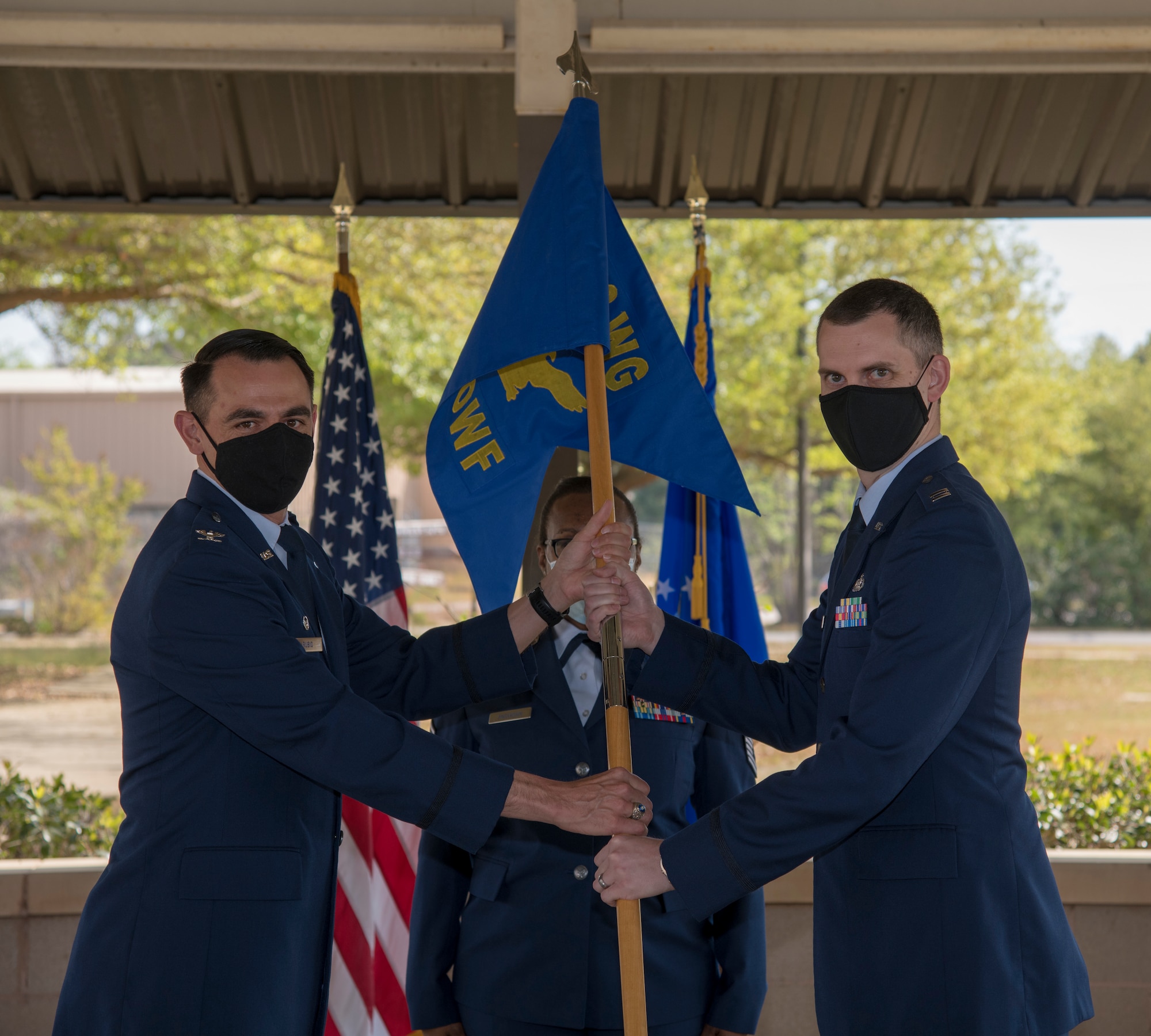 Col. Stuart M. Rubio, 403rd operations group commander at Keesler Air Force Base, Miss., hands the 5th Operational Weather Flight guidon to new commander Capt. Grant J. Talkington during an assumption of command ceremony at the 28th Operational Weather Squadron pavilion at Shaw Air Force Base, S.C. April 9, 2021. The flight is a geographically separated unit assigned to the Air Force Reserve's 403rd Wing.(U.S. Air Force photo by Staff Sgt. Kristen Pittman)