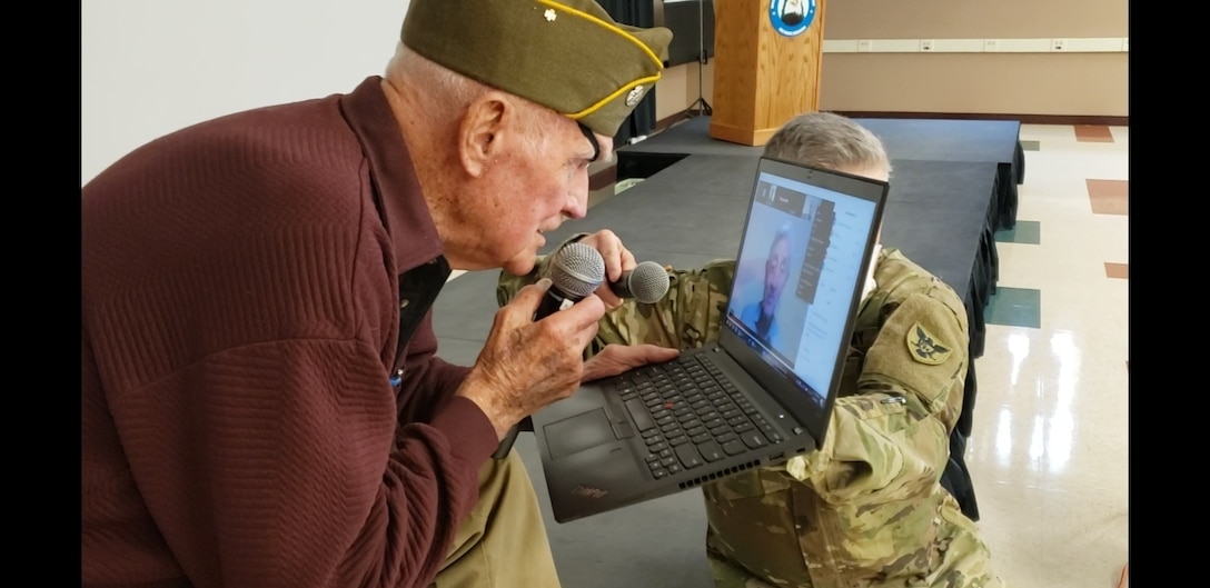 Tom Sitter, World War II veteran and Days of Remembrance speaker for the 86th Training Division is surprised with a teleconference meeting with a Dachau survivor, Elly Gotz, at Fort McCoy, Wis., April 9. Sitter was one of the Soldiers who liberated Dachau. (U.S. Army Reserve photo by Sgt. 1st Class Debralee Best/86th Training Division)