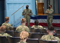Lt. Travis Greenaway  and LTJG CJ Sarai speak to midshipmen during a question and answer session, April 10. 180 midshipmen from the United States Naval Academy (USNA) visited Naval Station Norfolk, April 10-11. This is the first of several fleet orientation weekends in April which will introduce more than 500 midshipmen to the surface and amphibious warfare force. (U.S. Navy photo by Mass Communication Specialist 2nd Class Jacob Milham/Released)