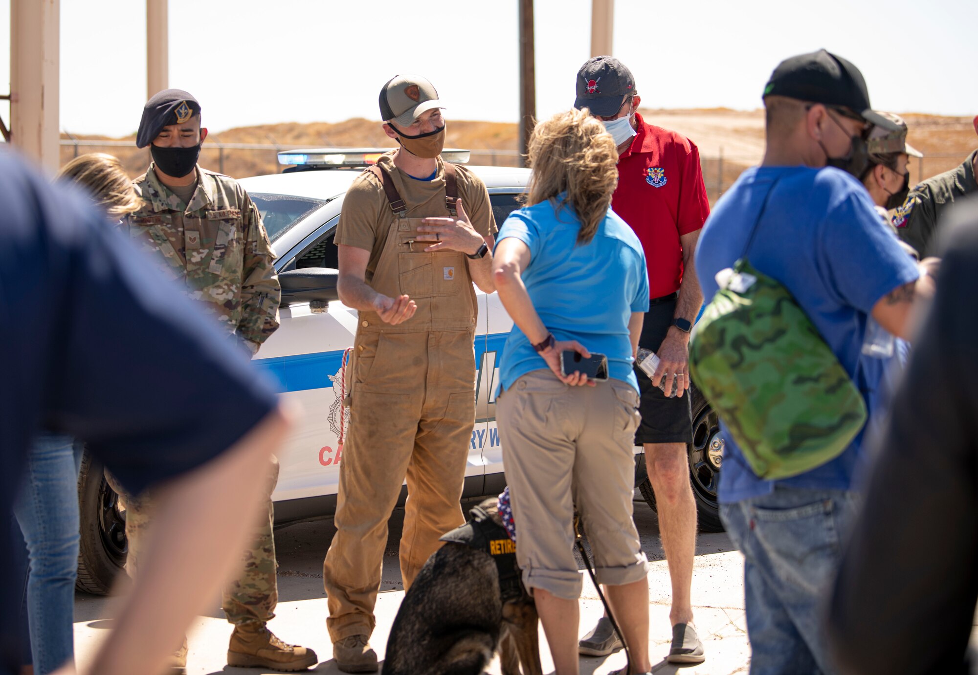 Staff Sgt. Zachory Boozel, a 56th Security Forces Squadron military working dog handler, briefs new Honorary Commanders of the 944th Fighter Wing on military working dog operations and capabilities at Luke Air Force Base, Arizona, April 10, 2021. The 944th FW inducted the 2021-2023 class of Honorary Commanders on as part of the wing’s ongoing community outreach program.