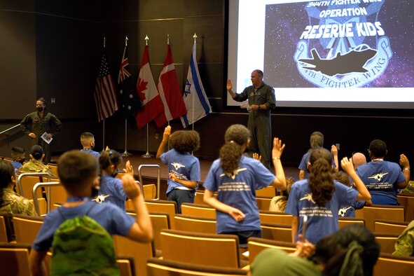 Reserve Citizen Airman Col Sean Rassas, 944th Fighter Wing vice commander, swears in children as the respond to their mock deployment recall during Operation Reserve Kids, at Luke Air Force Base, Arizona, April 10, 2021. The purpose of the event was to help the children gain a better understanding of the deployment process their parents go through as well as the different career fields within the Air Force.