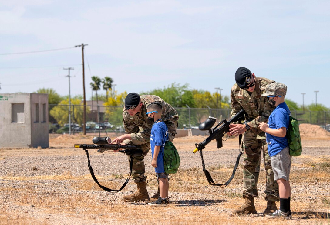 Reserve Citizen Airmen of the 944th Security Forces Squadron give a demonstration and let military children fire M4 paintball training rounds at targets while participating in Operation Reserve Kids on Luke Air Force Base, Arizona, April 10, 2021. During the Month of the Military Child, the 944th FW hosted and gave a tour to raise awareness for the children of what their parents do as part of their Reserve duty.