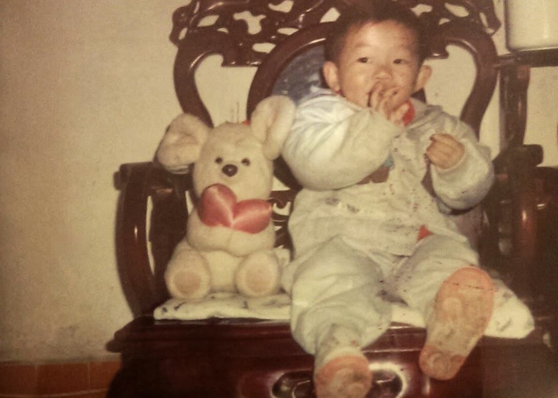 Army Reserve Spc. Feiyu He, seen here as a toddler, deployed to Camp Arifjan, Kuwait, with the Lancaster, Pennsylvania-based 1185th Deployment and Distribution Support Battalion. The Chinese-born He is applying for U.S. citizenship with the support of the 1st Theater Sustainment Command's operational command post. (Photo courtesy of Feiyu He)