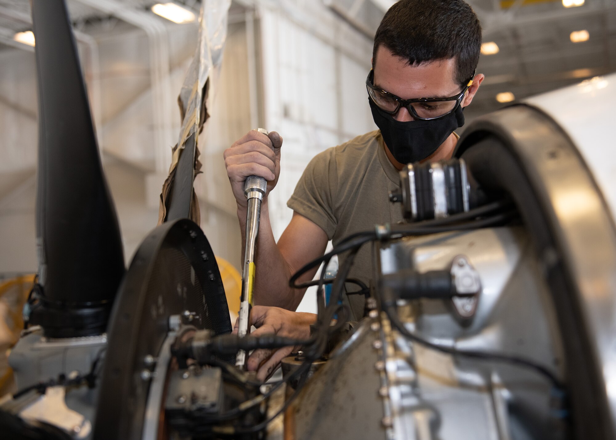 Airman tightens bolts