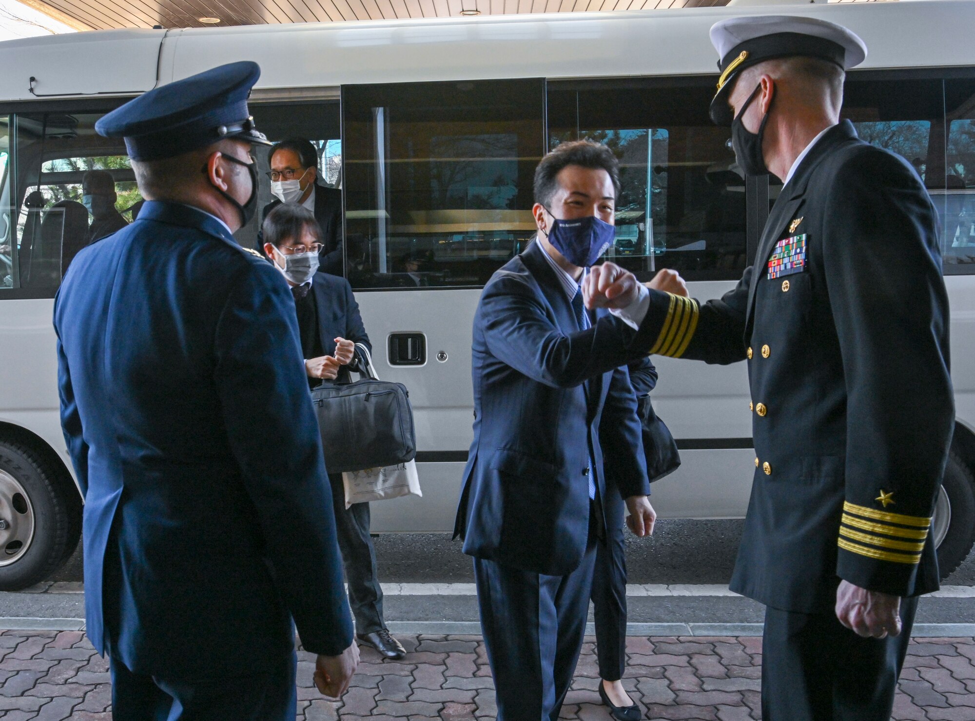 U.S. Air Force Col. Jesse Friedel, left, Misawa Air Base installation commander, and U.S. Navy Capt. Brian Pummill, right, Naval Air Facility Misawa commanding officer, greet Takashi Uto, Japan State Minister of Foreign Affairs, at Misawa Air Base, Japan, April 12, 2021. Uto visited the base to meet with U.S. and Japanese military leaders to learn about the mission and challenges of the bilateral and joint base. (U.S. Air Force photo by Tech. Sgt. Timothy Moore)