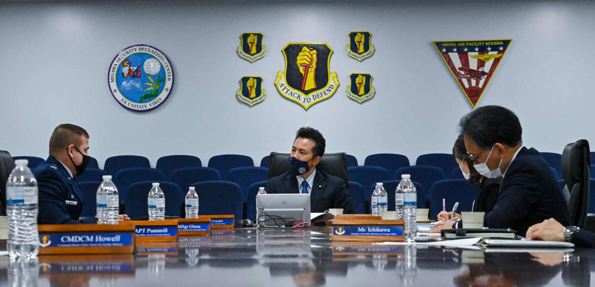 Takashi Uto, center, Japan State Minister of Foreign Affairs, listens to a brief from U.S. Air Force Col. Jesse Friedel, Misawa Air Base installation commander, during his visit to Misawa Air Base, Japan, April 12, 2021. During the briefing, Uto and base leaders discussed the base's mission and relationships within the local community, Japan, and Indo-Pacific Command in general. (U.S. Air Force photo by Tech. Sgt. Timothy Moore)