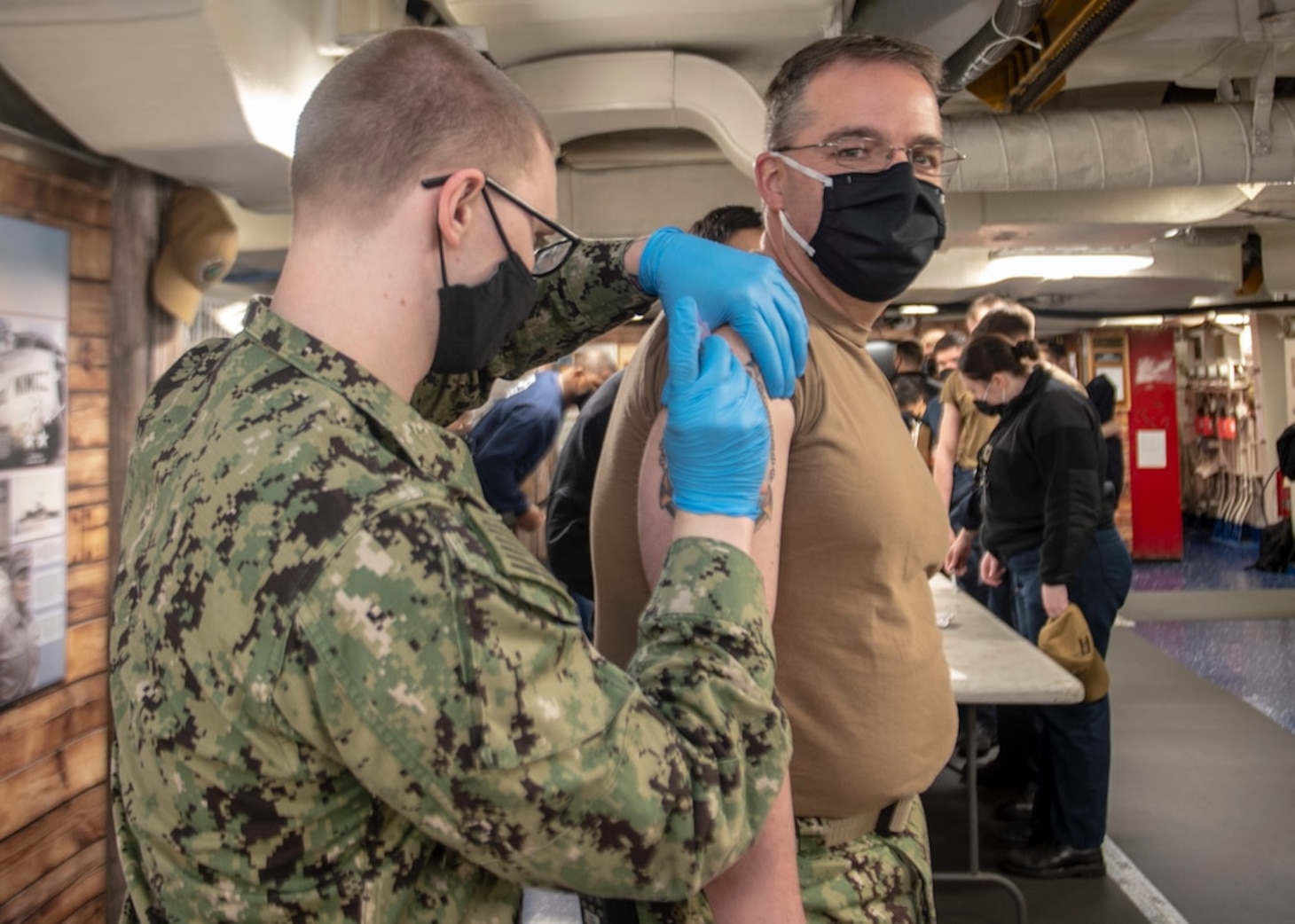 Command Master Chief David Conduff, assigned to USS Nimitz (CVN 68), receives the Moderna COVID-19 vaccine aboard Nimitz. Nimitz is currently in port preparing for future operations.