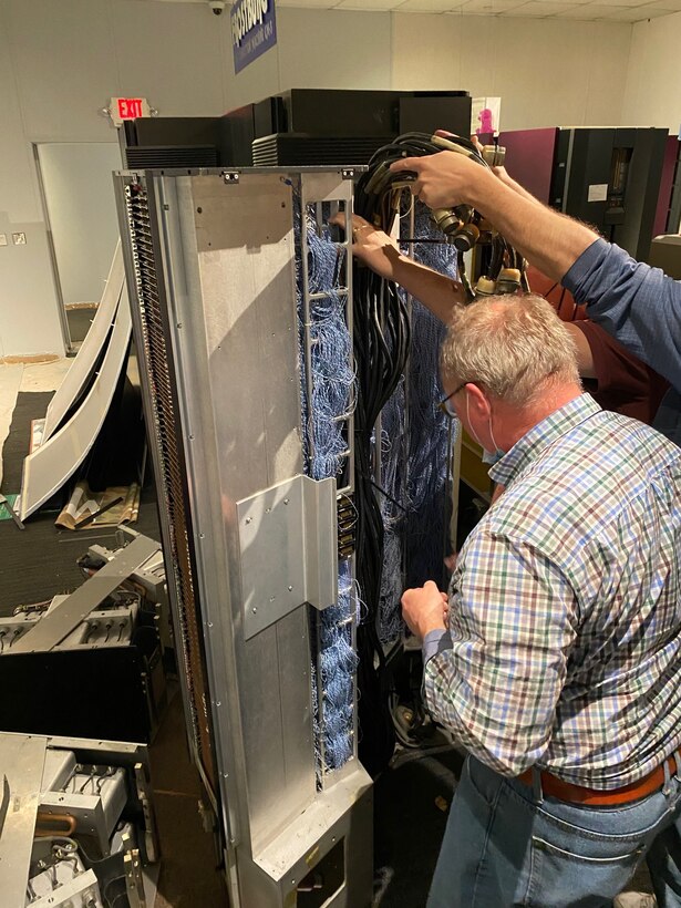 Electricians carefully move one of NSA’s first supercomputers