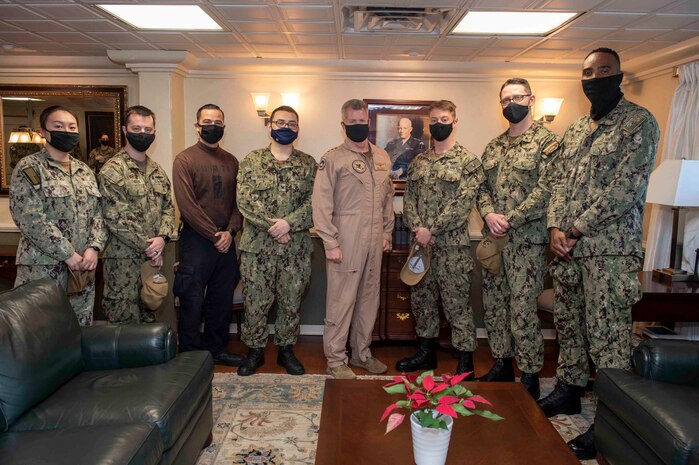 210411-N-AY174-1041 DUQM (April 11, 2021) - Vice Adm. Samuel Paparo, commander of U.S. Naval Forces Central Command (NAVCENT), U.S. 5th Fleet and Combined Maritime Forces, center, poses for a photo with Sailors aboard aircraft carrier USS Dwight D. Eisenhower (CVN 69) during a sustainment and logistics visit in Duqm, Oman, April 11. The Eisenhower Carrier Strike Group is deployed to the U.S. 5th Fleet area of operations in support of naval operations to ensure maritime stability and security in the Central Region, connecting the Mediterranean and Paciﬁc through the western Indian Ocean and three strategic choke points. (U.S. Navy photo by Mass Communication Specialist 3rd Class Brianna T. Thompson-Lee/Released)