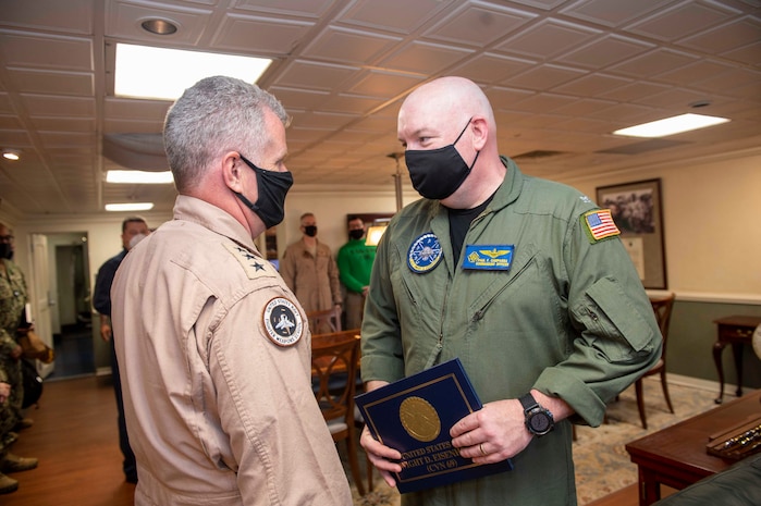 210411-N-AY174-1044 DUQM (April 11, 2021) - Vice Adm. Samuel Paparo, commander of U.S. Naval Forces Central Command (NAVCENT), U.S. 5th Fleet and Combined Maritime Forces, left, speaks to Capt. Paul Campagna, commanding ofﬁcer of aircraft carrier USS Dwight D. Eisenhower (CVN 69), during a sustainment and logistics visit in Duqm, Oman, April 11. The Eisenhower Carrier Strike Group is deployed to the U.S. 5th Fleet area of operations in support of naval operations to ensure maritime stability and security in the Central Region, connecting the Mediterranean and Paciﬁc through the western Indian Ocean and three strategic choke points. (U.S. Navy photo by Mass Communication Specialist 3rd Class Brianna T. Thompson-Lee/ Released)