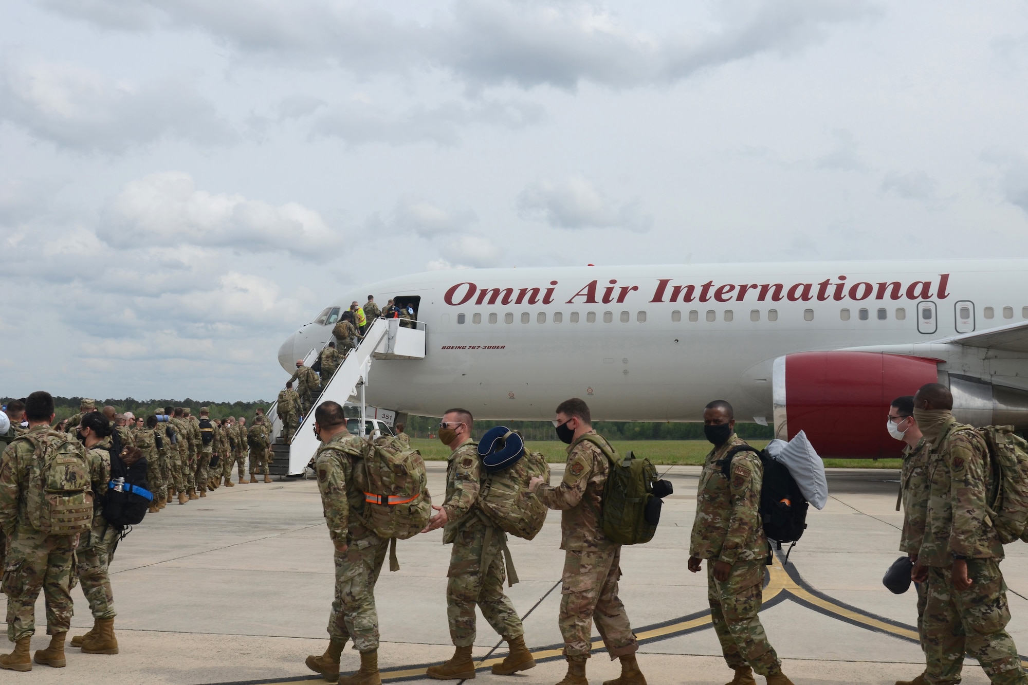 U.S. Air Force personnel, assigned to the South Carolina Air National Guard’s 169th Fighter Wing, load onto on a U.S. Air Force contracted Boeing 747 transport aircraft from McEntire Joint National Guard Base, South Carolina, to support an Air Expeditionary Force deployment to to Prince Sultan Air Base Saudi Arabia, April 11, 2021. The 169th Fighter Wing will support U.S. Central Command (CENTCOM) by preserving operational depth, staging joint forces and projecting overwhelming combat power in the region. This is the wing’s largest deployment since the summer of 2018 when they supported an Air Expeditionary Force rotation to Kuwait. (U.S. Air National Guard photo by Lt. Col. Jim St.Clair, 169th Fighter Wing Public Affairs)