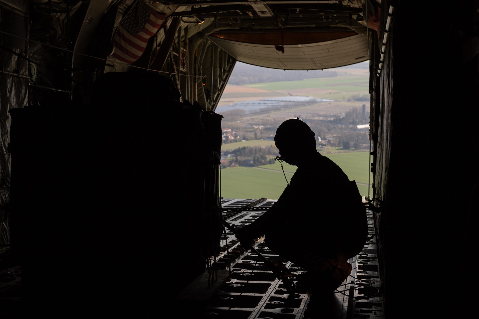 Silhouette of Airman kneeling on an aircraft.