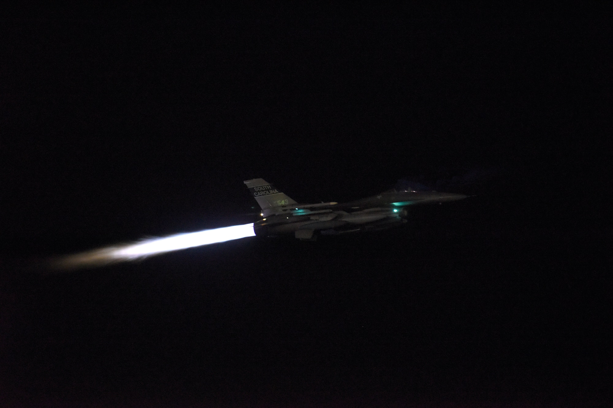 A U.S. Air Force F-16 Fighting Falcon fighter jet, assigned to the South Carolina Air National Guard’s 169th Fighter Wing, departs McEntire Joint National Guard Base, South Carolina, to support an Air and Space Expeditionary Force deployment to Prince Sultan Air Base, Southwest Asia, April 12, 2021. The 169th Fighter Wing will support U.S. Central Command (CENTCOM) by preserving operational depth, staging joint forces and projecting overwhelming combat power in the region. This is the wing’s largest deployment since the summer of 2018 when they supported an Air Expeditionary Force rotation to Kuwait. (U.S. Air National Guard photo by Senior Master Sgt. Edward Snyder, 169th Fighter Wing Public Affairs)