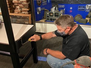 Artifact display cases get a fresh coat of paint.