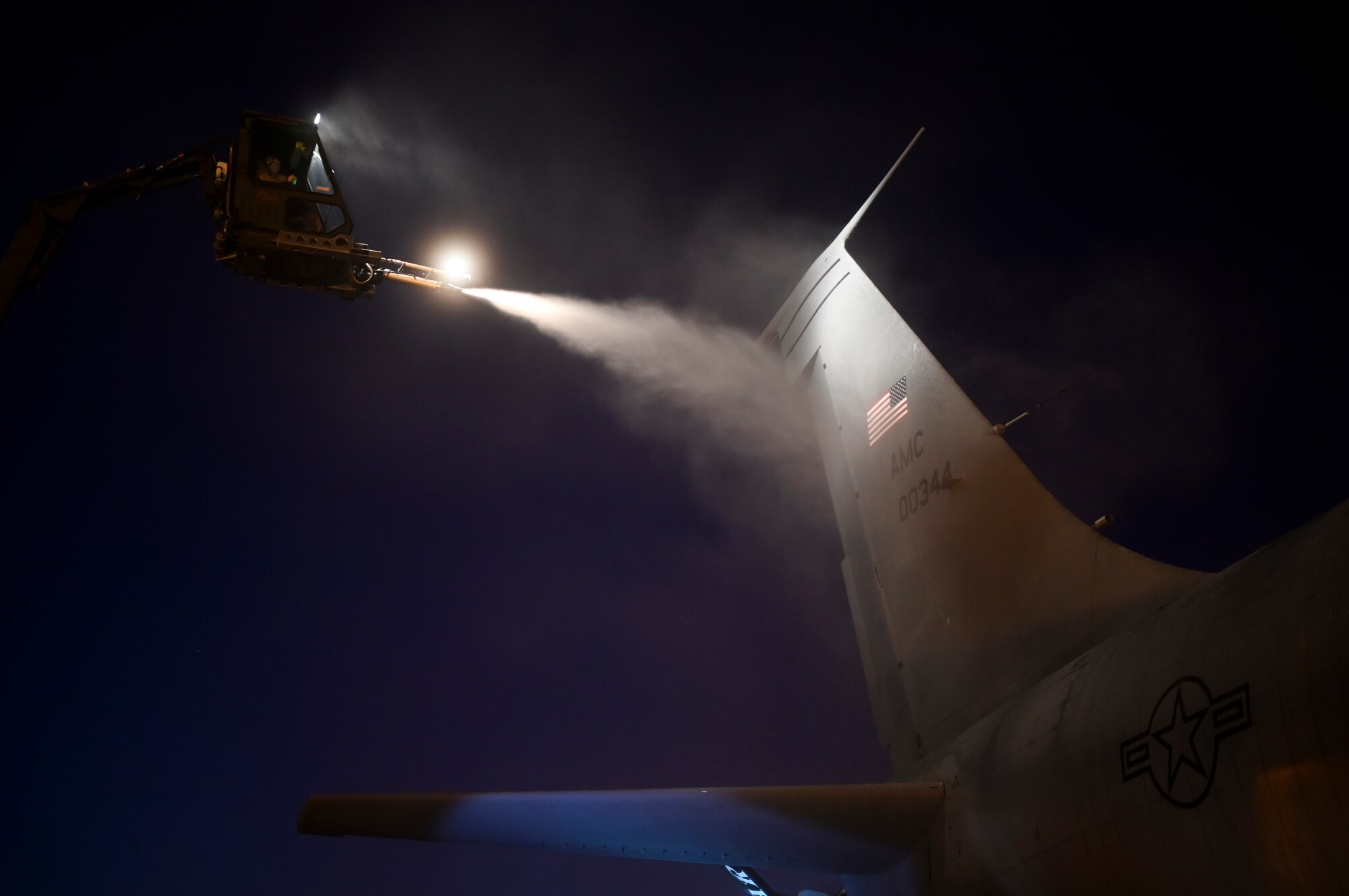 U.S. Airmen assigned to the 100th Aircraft Maintenance Squadron de-ice a KC-135 Stratotanker aircraft prior to a flight supporting a Bomber Task Force mission at Royal Air Force Mildenhall, England, April 12, 2021. The U.S. routinely and visibly demonstrates commitment to allies and partners through the global employment of its military forces. (U.S. Air Force photo by Tech. Sgt. Emerson Nuñez)