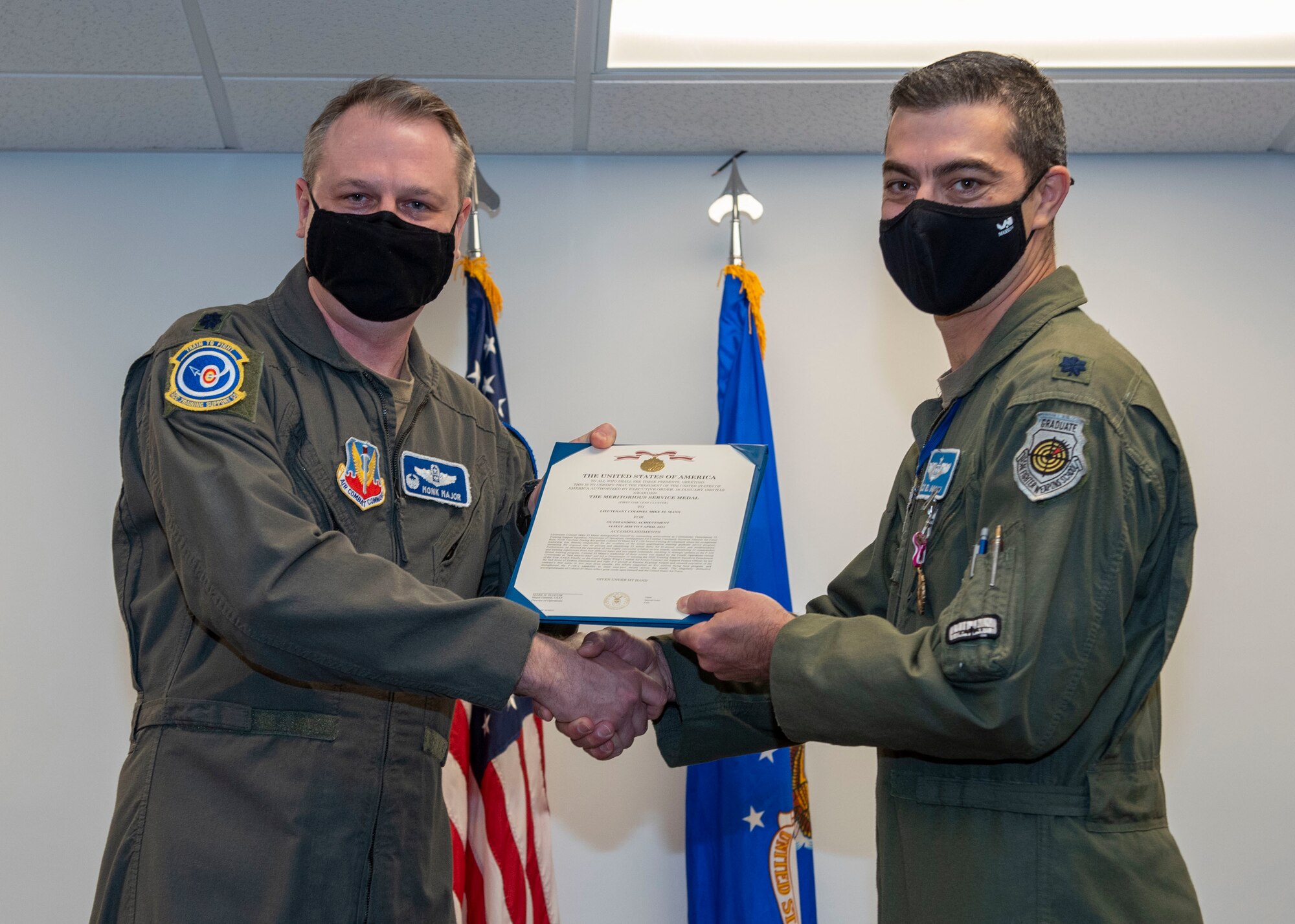 Lt. Col. Scott Major, left, Air Combat Command Training Support Squadron commander, presents Lt. Col. Mike El Mann, Headquarters Training Support Squadron Detachment 15 commander, with the meritorious service medal at the Detachment 15 change of command ceremony at Seymour Johnson Air Force Base, North Carolina, April 9, 2021.